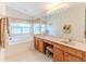 Bathroom with double vanity, soaking tub and tile floor at 11544 Mcleod St, Spring Hill, FL 34609