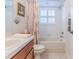 Bathroom with tub, shower, and wood vanity at 11544 Mcleod St, Spring Hill, FL 34609