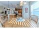 Round breakfast table with chairs in sunlit nook at 11544 Mcleod St, Spring Hill, FL 34609