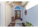 Inviting entryway with a wooden bench, decorative wall art, and a glass door at 11544 Mcleod St, Spring Hill, FL 34609