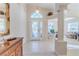 Spacious entryway with an arched window, tile floors, and views into living area at 11544 Mcleod St, Spring Hill, FL 34609