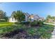 Side view of a single-story house showcasing a neatly landscaped yard at 11544 Mcleod St, Spring Hill, FL 34609