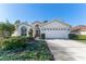 Front view of a single-story house with a two-car garage and nicely landscaped yard at 11544 Mcleod St, Spring Hill, FL 34609