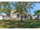 House exterior showcasing a screened patio and well-maintained lawn at 11544 Mcleod St, Spring Hill, FL 34609