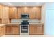 Bright kitchen with oak cabinets, stainless steel appliances, and an island at 11544 Mcleod St, Spring Hill, FL 34609