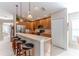 Modern kitchen with wooden cabinets, stainless steel appliances, and a breakfast bar at 11544 Mcleod St, Spring Hill, FL 34609