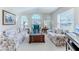 Comfortable living room with floral couches, a coffee table, and bay windows at 11544 Mcleod St, Spring Hill, FL 34609