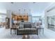 Spacious living room with a gray couch and view into the kitchen at 11544 Mcleod St, Spring Hill, FL 34609