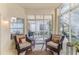 Relaxing sunroom, wicker chairs, and view of backyard at 11544 Mcleod St, Spring Hill, FL 34609