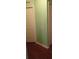 Hallway with light green walls and wood flooring at 12443 Tansboro St, Spring Hill, FL 34608