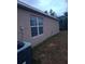 Side view of house with AC unit and window at 12443 Tansboro St, Spring Hill, FL 34608