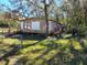 Mobile home with a fenced yard, situated on a spacious lot with mature trees at 12924 Manatee Ave, New Port Richey, FL 34654