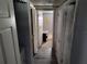 Hallway with gray flooring and doors to bedrooms at 12924 Manatee Ave, New Port Richey, FL 34654