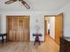 Bedroom with wood closet doors and hardwood floors at 1928 Gulfview Dr, Holiday, FL 34691