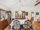 Bright dining room with hardwood floors and a formal dining set at 1928 Gulfview Dr, Holiday, FL 34691