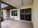 Covered entryway with stone accents, security door, and a bench at 1928 Gulfview Dr, Holiday, FL 34691