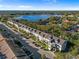 Aerial view of condo complex near a lake with lush greenery at 2210 Utopian E Dr # 212, Clearwater, FL 33763