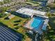 Aerial view of community pool, clubhouse, and solar panels at 2210 Utopian E Dr # 212, Clearwater, FL 33763