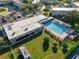 Community pool and surrounding landscape at 2210 Utopian E Dr # 212, Clearwater, FL 33763