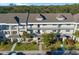 An aerial shot showcasing a condo building with lush landscaping and parking at 2210 Utopian E Dr # 212, Clearwater, FL 33763