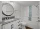 Bathroom with updated vanity, tub, and decorative tile at 2210 Utopian E Dr # 212, Clearwater, FL 33763