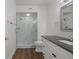 Modern bathroom with walk-in shower and dark vanity at 2210 Utopian E Dr # 212, Clearwater, FL 33763