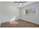 Well-lit bedroom featuring hardwood floors and a window at 2210 Utopian E Dr # 212, Clearwater, FL 33763