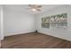 Spacious bedroom with hardwood floors and ceiling fan at 2210 Utopian E Dr # 212, Clearwater, FL 33763