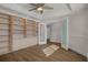 Spacious bedroom with hardwood floors and ample built-in shelving at 2210 Utopian E Dr # 212, Clearwater, FL 33763