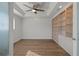 Bright bedroom with built-in shelving and hardwood floors at 2210 Utopian E Dr # 212, Clearwater, FL 33763