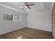 Bright and airy bedroom with hardwood floors and large window at 2210 Utopian E Dr # 212, Clearwater, FL 33763