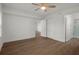 Bright bedroom with hardwood floors and ceiling fan at 2210 Utopian E Dr # 212, Clearwater, FL 33763