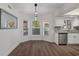 Modern dining area with bay window and view into updated kitchen at 2210 Utopian E Dr # 212, Clearwater, FL 33763
