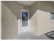 White front door of condo unit with glass panel at 2210 Utopian E Dr # 212, Clearwater, FL 33763