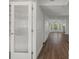 Bright hallway with hardwood floors leading to living area at 2210 Utopian E Dr # 212, Clearwater, FL 33763