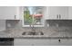 Kitchen boasts granite countertops and a double sink at 2210 Utopian E Dr # 212, Clearwater, FL 33763