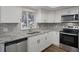 Updated kitchen with stainless steel appliances and granite countertops at 2210 Utopian E Dr # 212, Clearwater, FL 33763