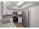 Modern kitchen featuring stainless steel appliances and granite countertops at 2210 Utopian E Dr # 212, Clearwater, FL 33763