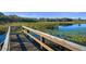 Serene wooden dock overlooking a calm lake at 2210 Utopian E Dr # 212, Clearwater, FL 33763