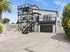 Modern two-story home with black and white exterior and attached garage at 3232 Gulf Coast Dr, Hernando Beach, FL 34607