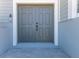 Double front doors with modern hardware and gray finish at 3240 Spanish Bayonet Dr, Hernando Beach, FL 34607