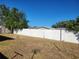 Large backyard with a white vinyl fence and grassy area at 3249 Trask Dr, Holiday, FL 34691