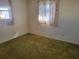 Simple bedroom with window and carpet flooring at 3249 Trask Dr, Holiday, FL 34691