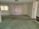 Living room with green carpet and sliding glass doors at 3249 Trask Dr, Holiday, FL 34691