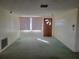 Living room with green carpet and window at 3249 Trask Dr, Holiday, FL 34691