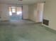 Living room with green carpet and sliding glass doors to patio at 3249 Trask Dr, Holiday, FL 34691