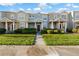 Daytime view of charming two-story townhome with landscaped yard at 3411 Broken Bow Dr, Land O Lakes, FL 34639