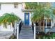 Inviting front entrance with blue door and a gray staircase at 403 48Th Street W Ct, Palmetto, FL 34221