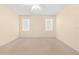 Well-lit bedroom with carpet flooring and ceiling fan at 4201 Silver Berry Ct, Spring Hill, FL 34609