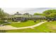 Large clubhouse with expansive lawn and golf cart parking at 4201 Silver Berry Ct, Spring Hill, FL 34609